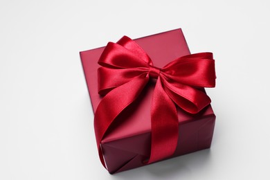 Photo of Gift box with bow on light grey background