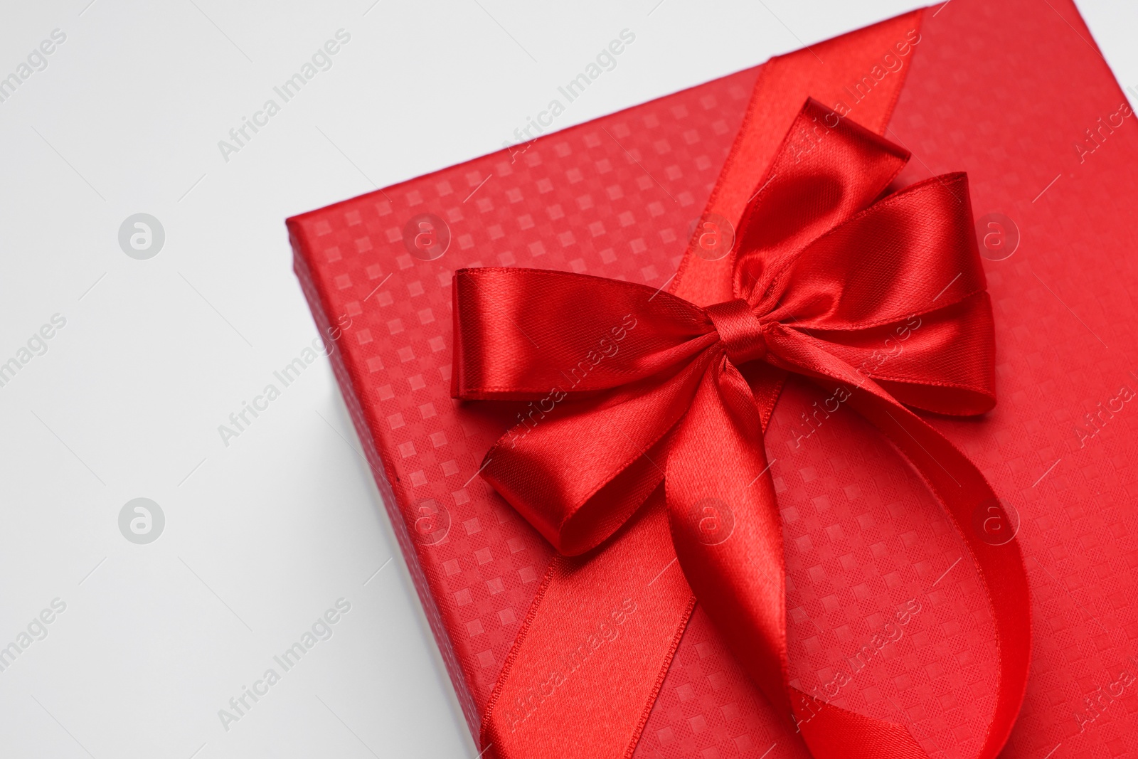 Photo of Gift box with bow on light grey background