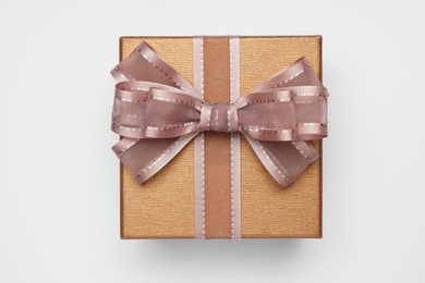 Photo of Gift box with bow on light grey background, top view