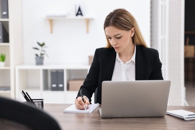 Photo of Banker working at wooden table in office