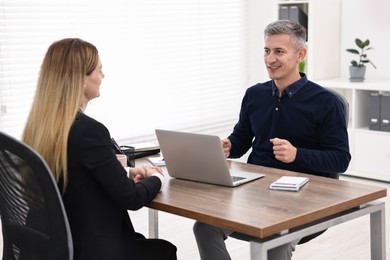 Banker working with client at table in office