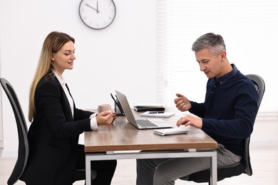 Banker working with client at table in office