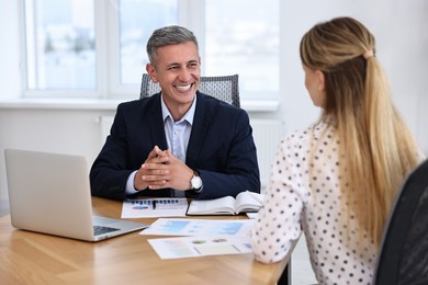 Banker working with client at table in office