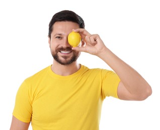 Happy man covering eye with lemon on white background