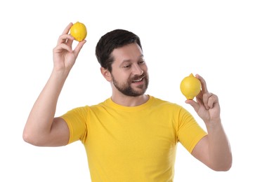 Happy man holding lemons on white background