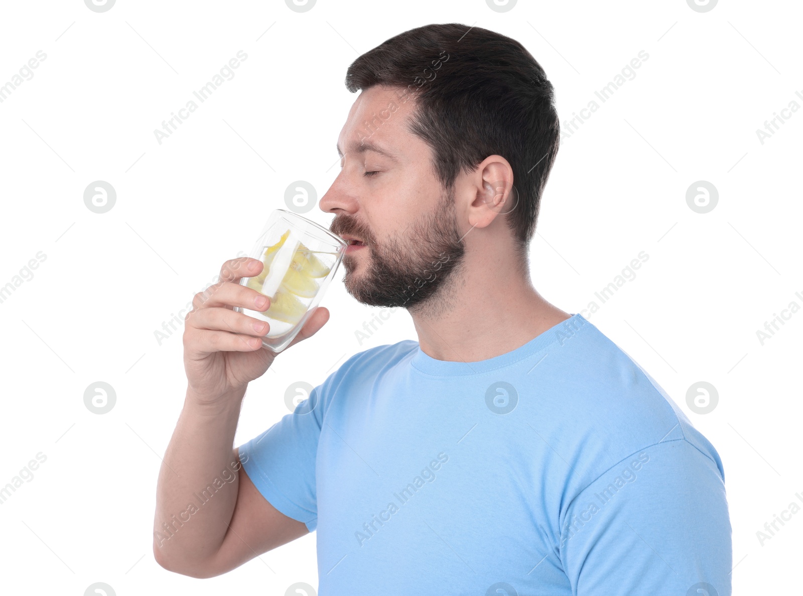 Photo of Handsome man drinking water with lemon on white background