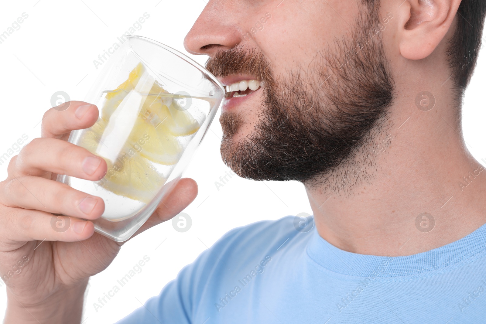 Photo of Happy man drinking water with lemon on white background, closeup