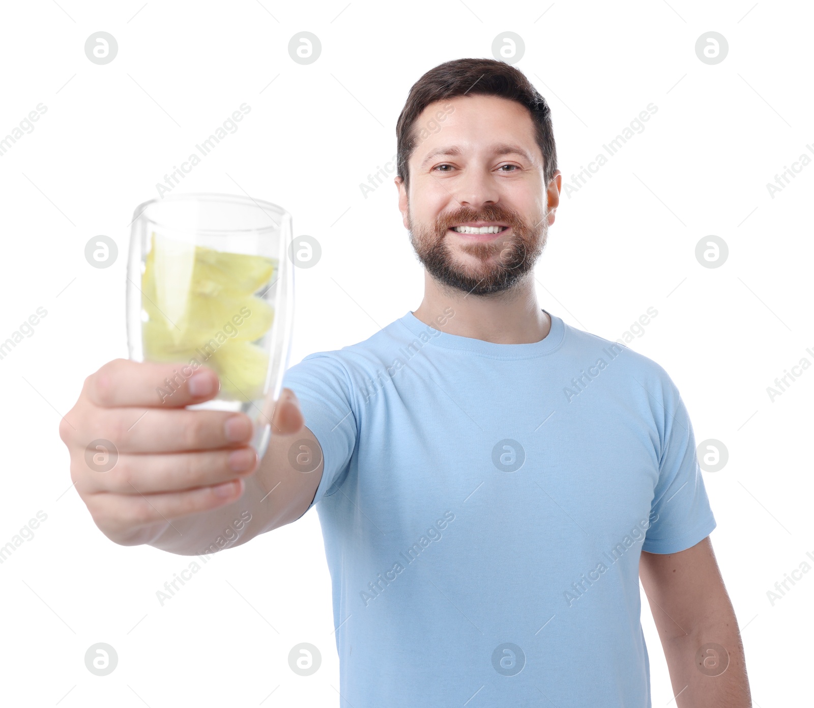 Photo of Happy man showing glass of water with lemon on white background