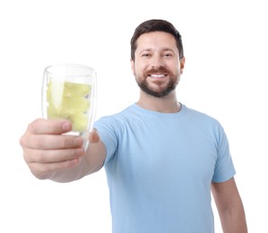 Photo of Happy man showing glass of water with lemon on white background