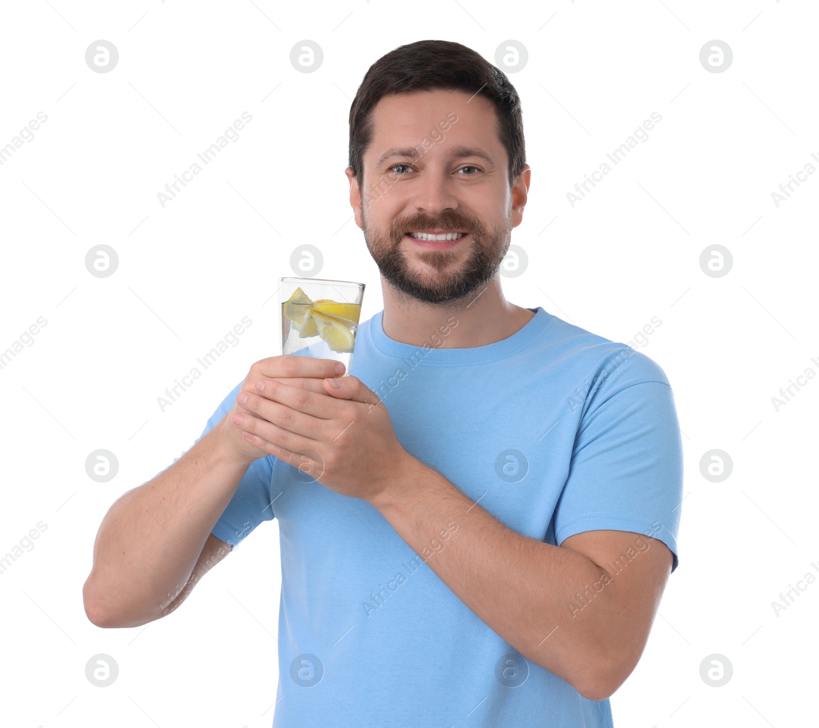 Photo of Happy man holding glass of water with lemon on white background