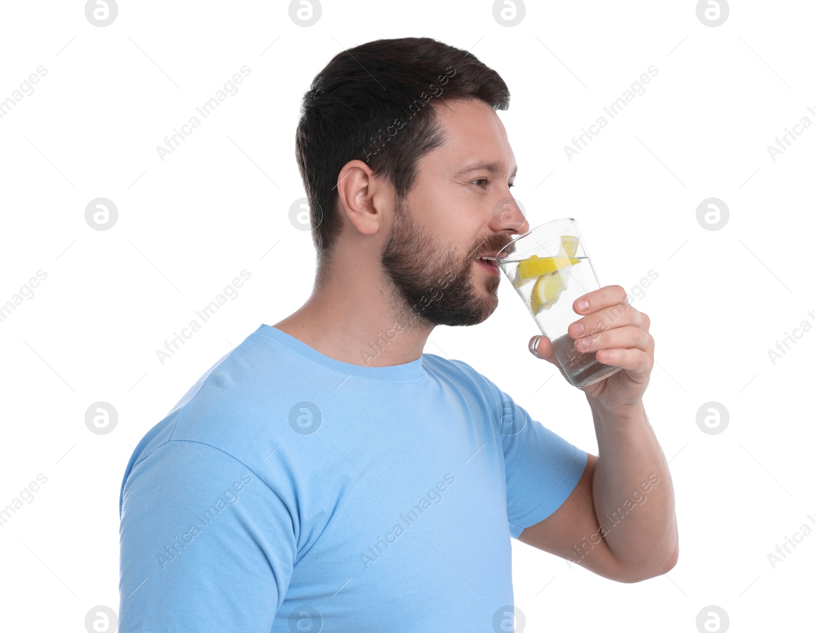 Photo of Handsome man drinking water with lemon on white background