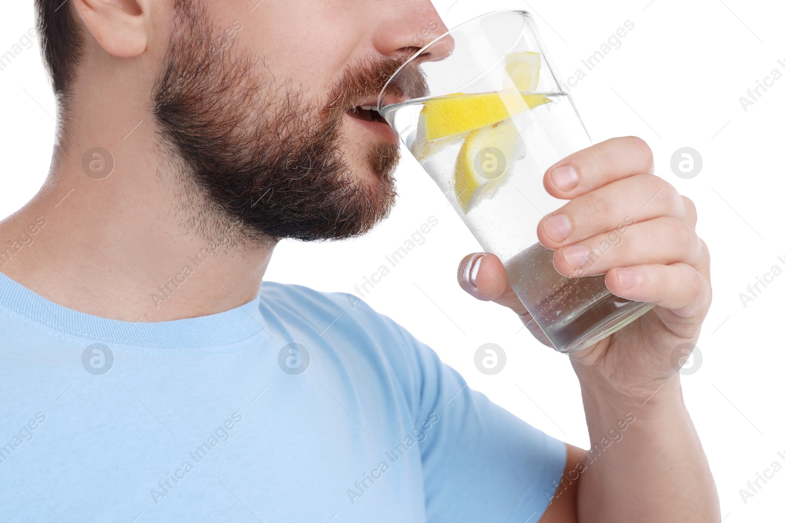 Photo of Man drinking water with lemon on white background, closeup