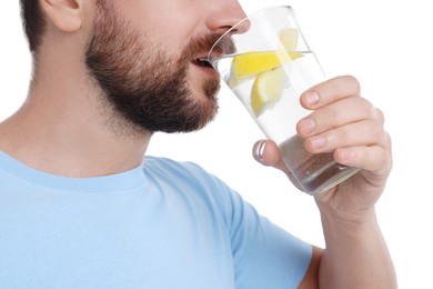 Man drinking water with lemon on white background, closeup