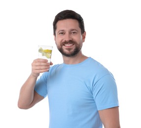 Photo of Happy man holding glass of water with lemon on white background