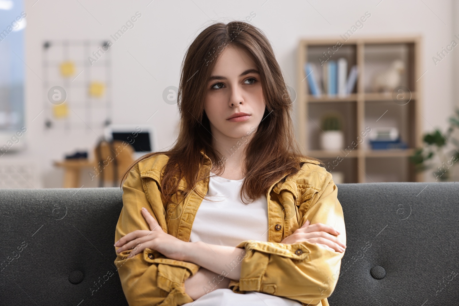 Photo of Loneliness concept. Sad teenage girl on sofa at home