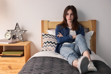 Photo of Loneliness concept. Sad teenage girl on bed at home