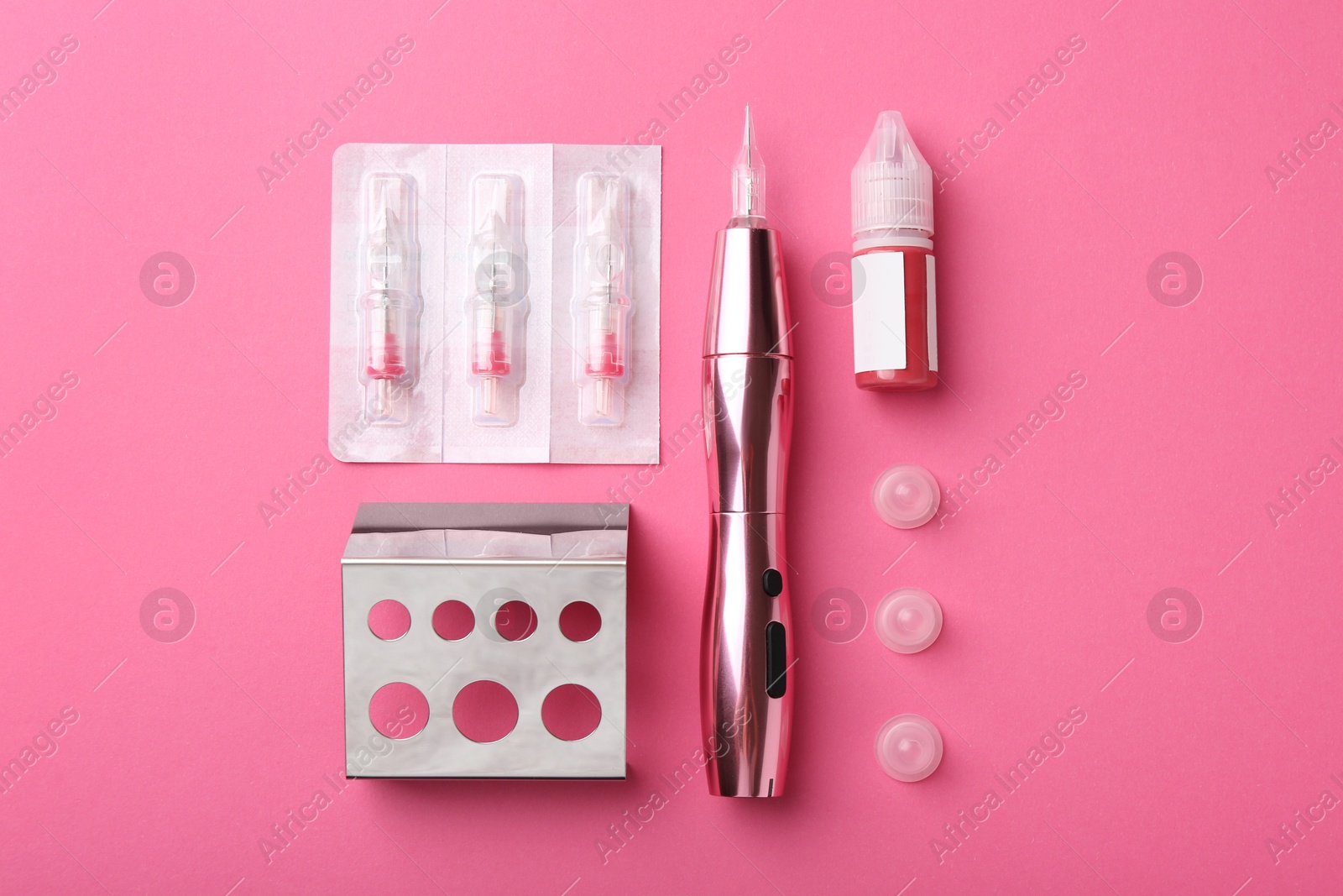 Photo of Permanent makeup equipment kit on pink background, flat lay