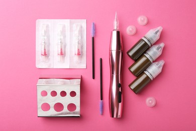 Photo of Permanent makeup equipment kit on pink background, flat lay