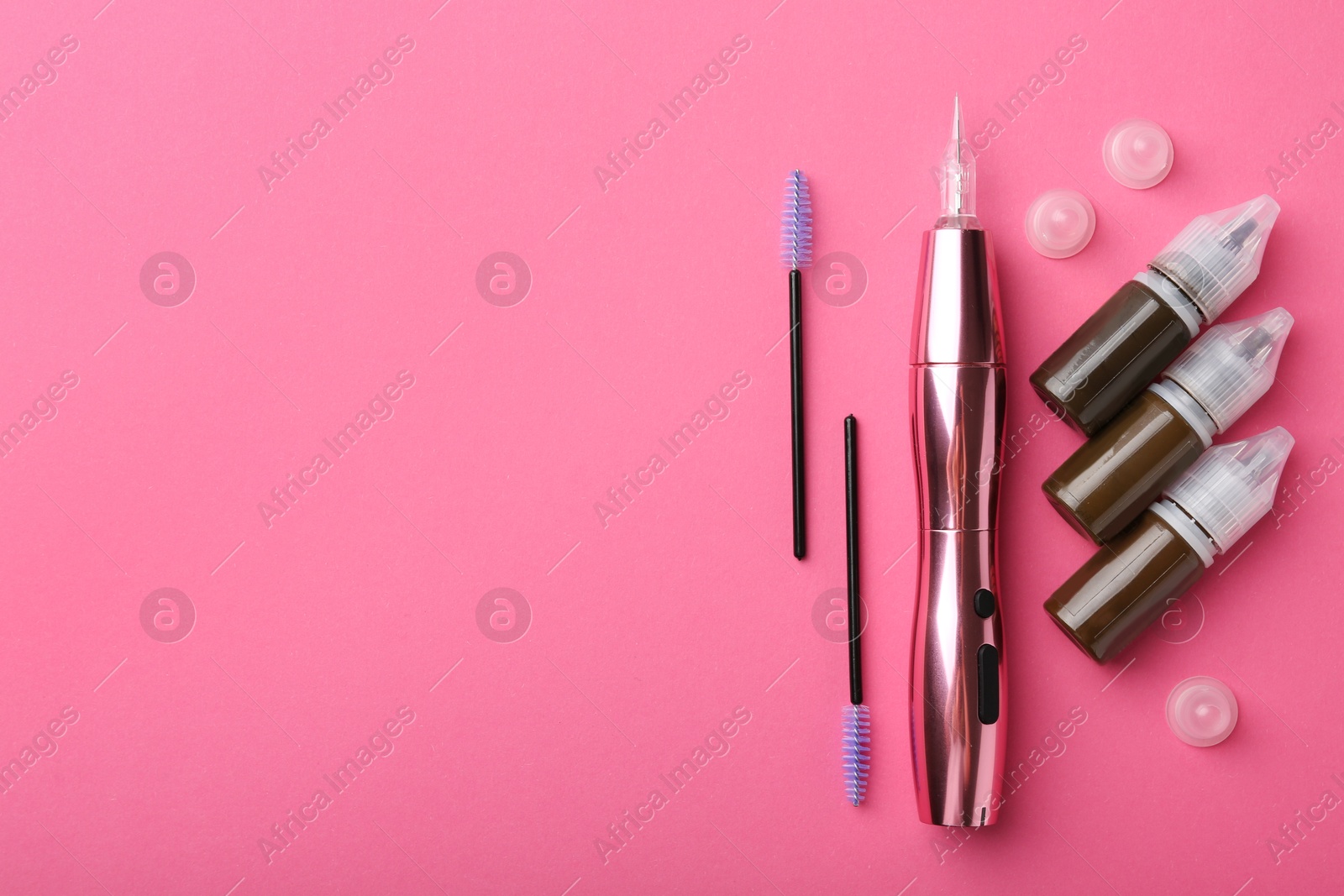 Photo of Permanent makeup equipment kit on pink background, flat lay. Space for text