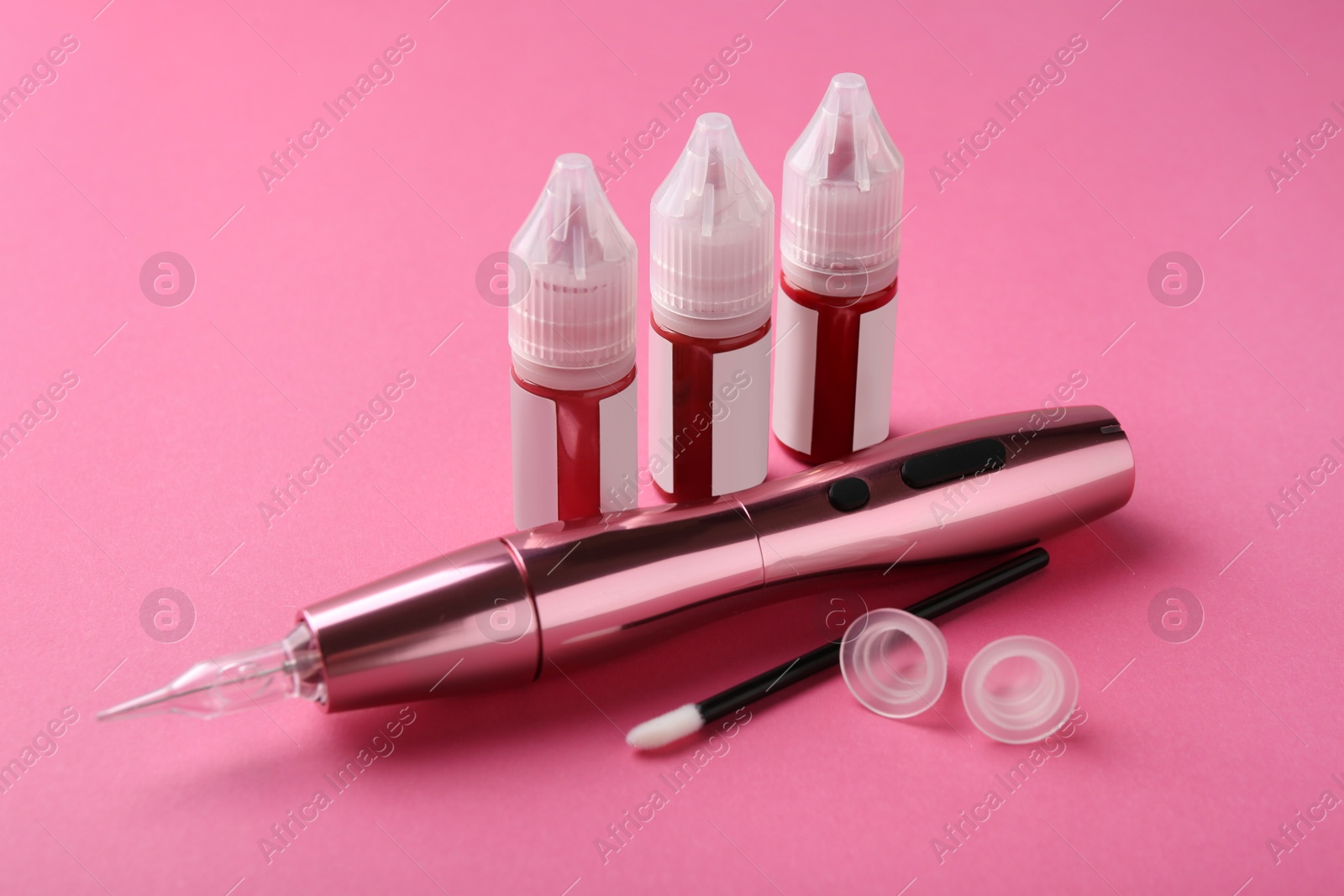 Photo of Permanent makeup equipment kit on pink background