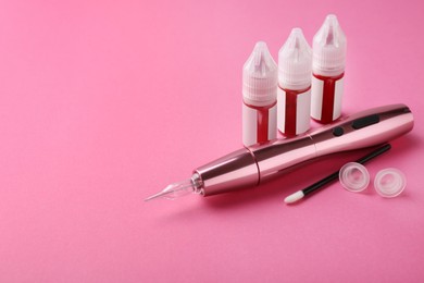 Permanent makeup equipment kit on pink background. Space for text