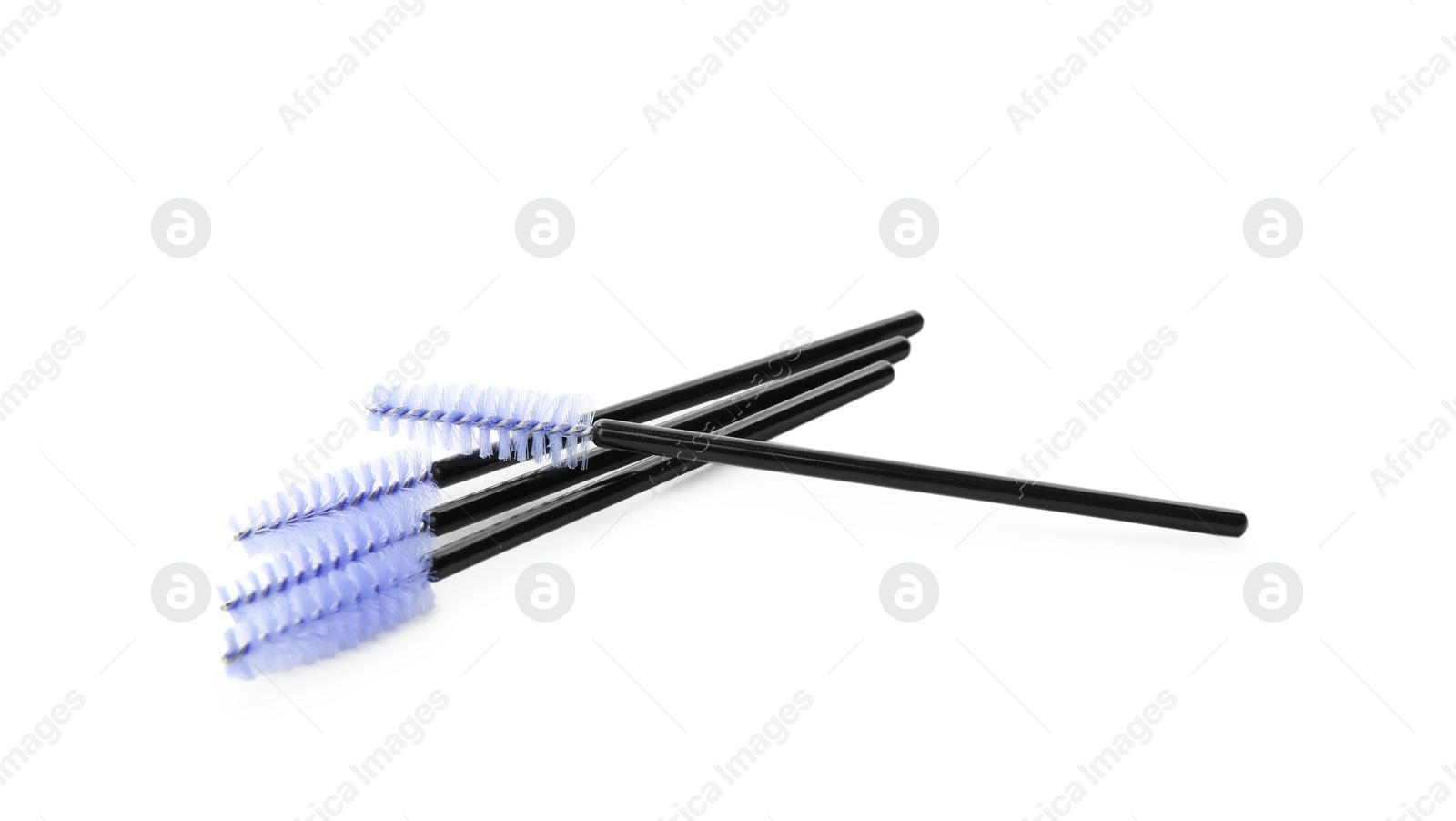 Photo of Many disposable makeup brushes isolated on white