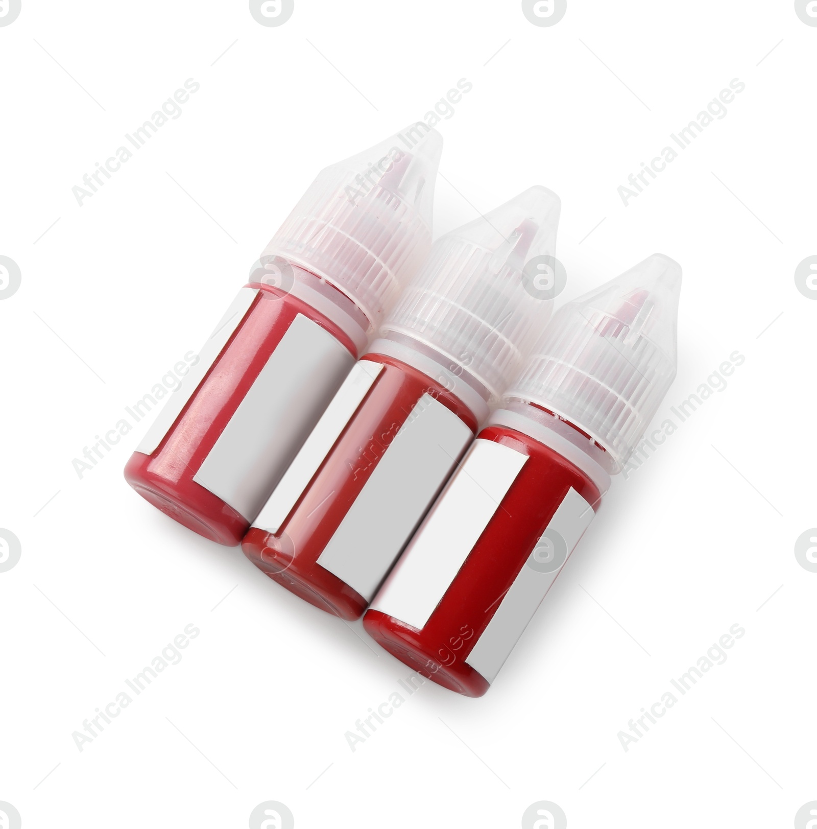 Photo of Bottles of pigments for permanent makeup isolated on white, top view