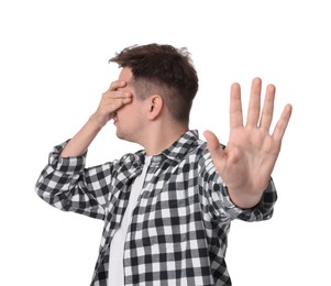 Portrait of scared young man on white background