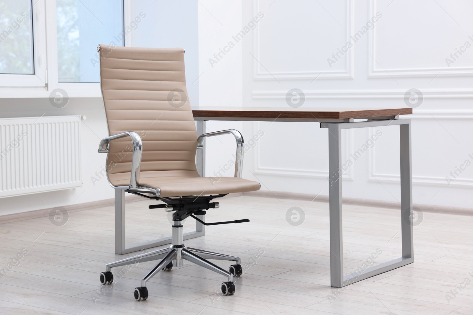 Photo of Beige leather chair and desk in office