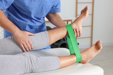 Physiotherapist working with senior patient in rehabilitation center, closeup