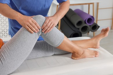 Physiotherapist working with senior patient in rehabilitation center, closeup