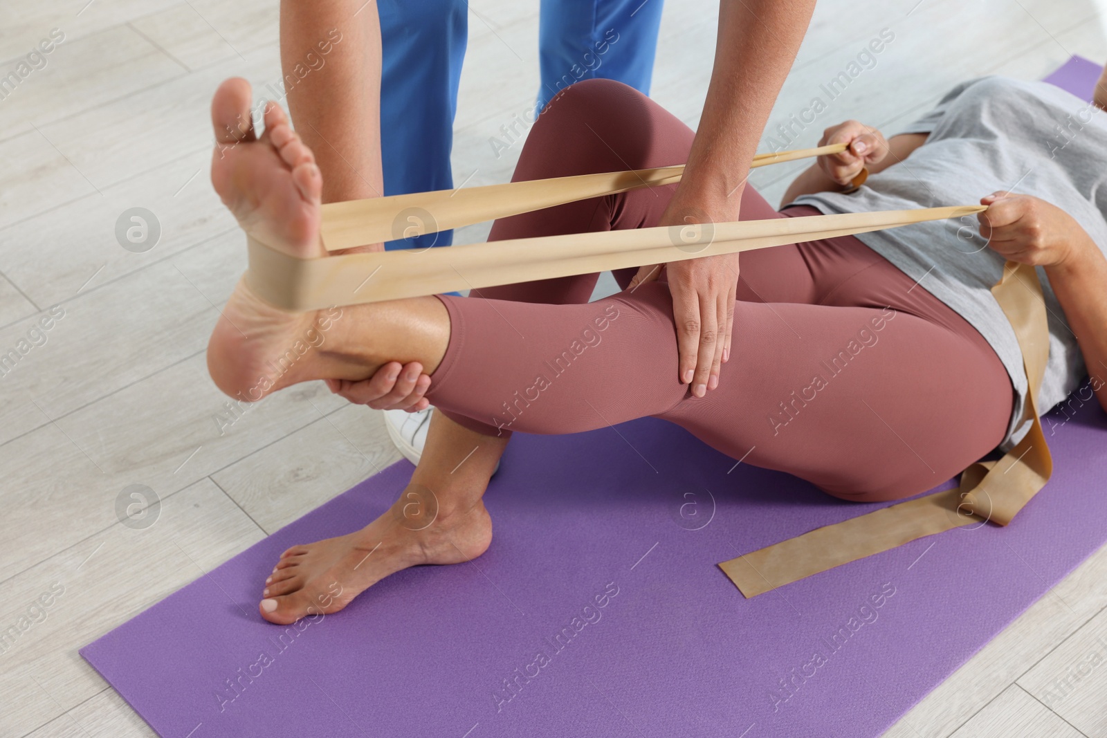 Photo of Physiotherapist working with senior patient in rehabilitation center, closeup