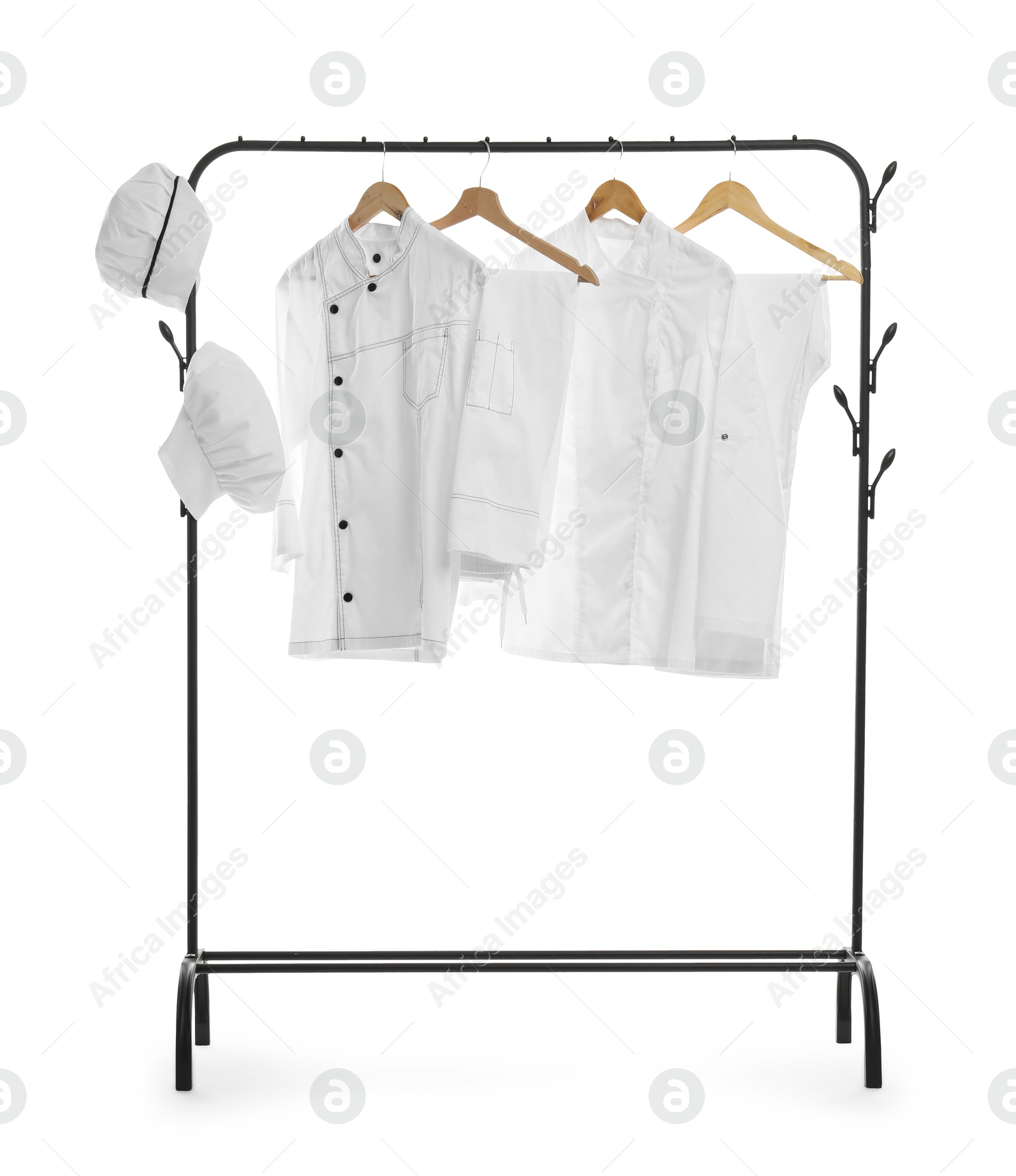 Photo of Different chef's uniforms on clothing rack against white background