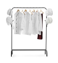 Photo of Different chef's uniforms on clothing rack against white background