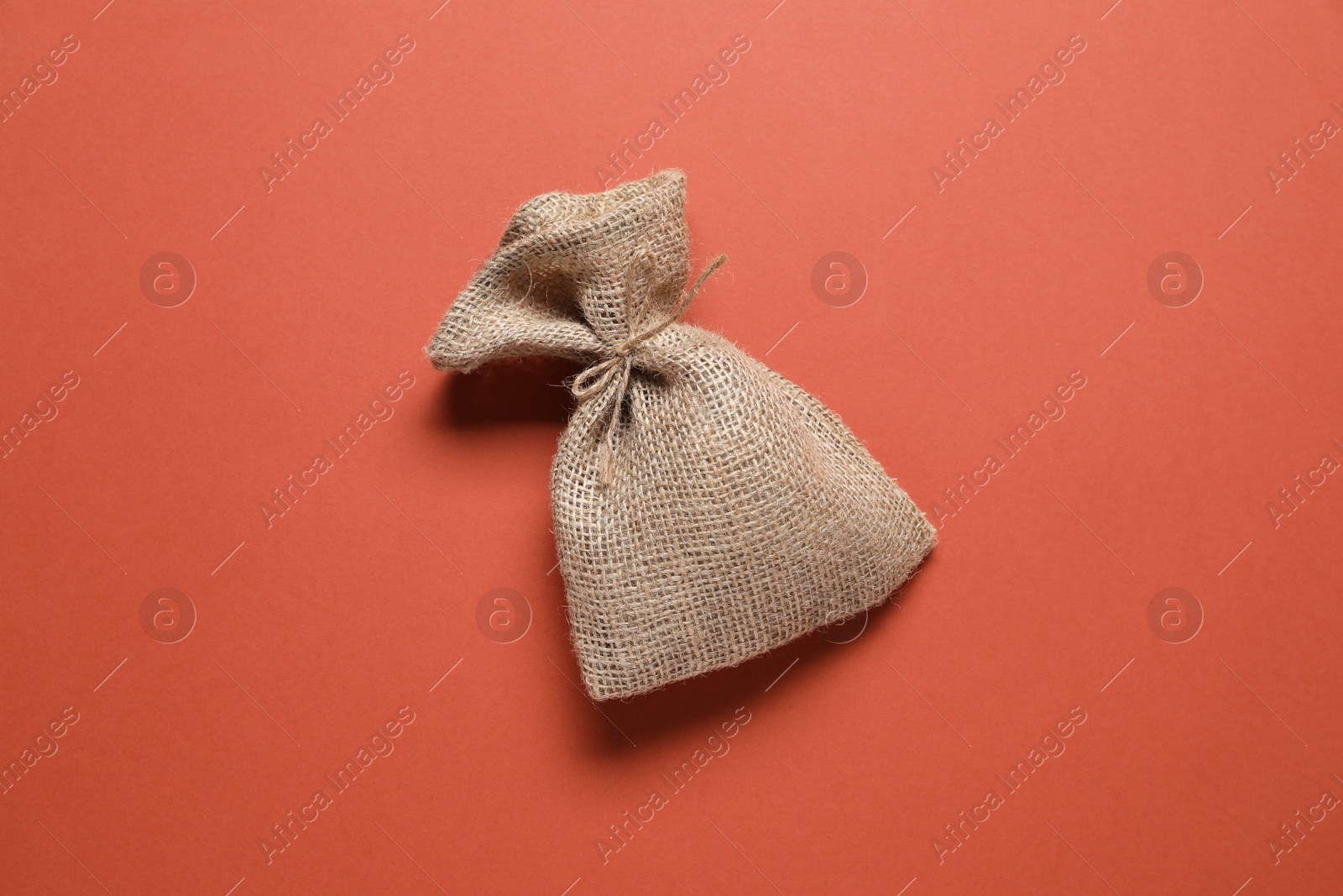 Photo of One burlap sack on color background, top view