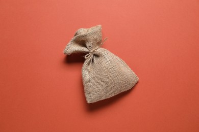 One burlap sack on color background, top view