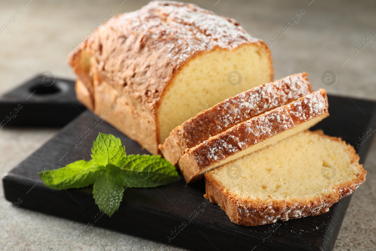 Photo of Freshly baked sponge cake on light grey table, closeup