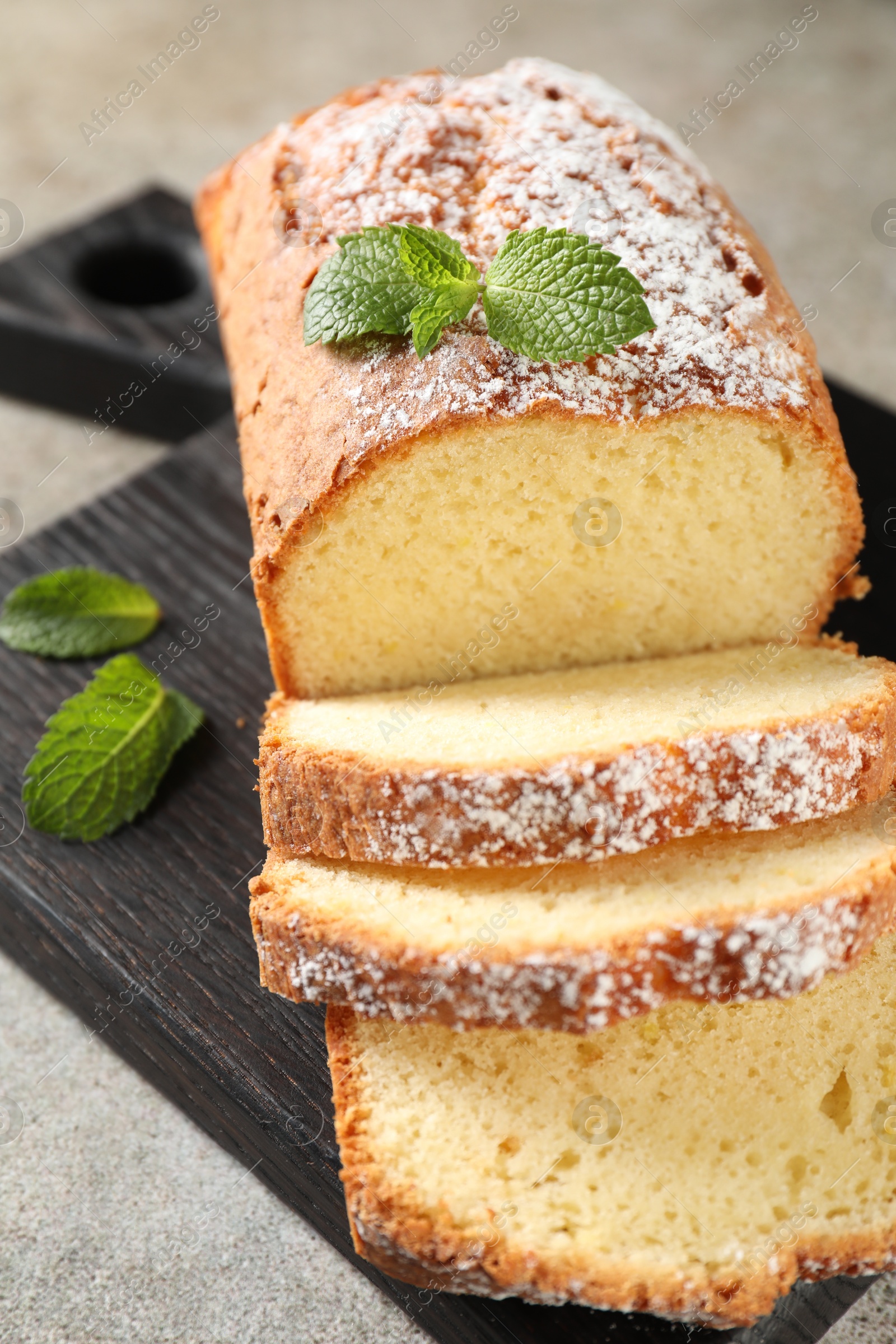 Photo of Freshly baked sponge cake on light grey table, closeup