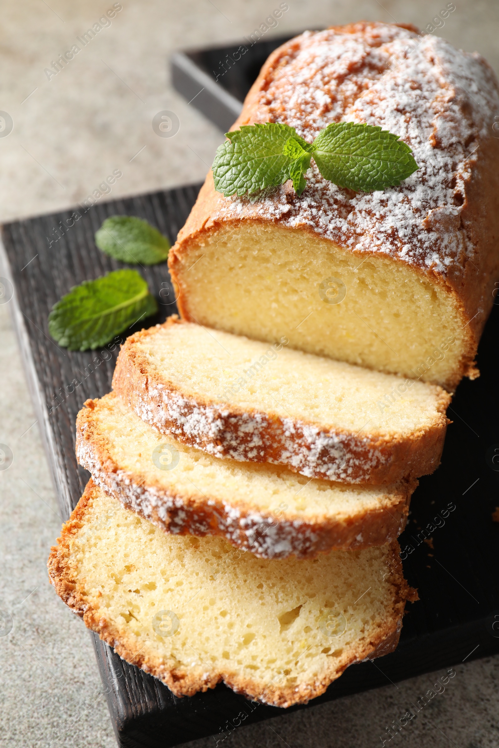 Photo of Freshly baked sponge cake on light grey table, closeup