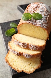 Photo of Freshly baked sponge cake on light grey table, closeup