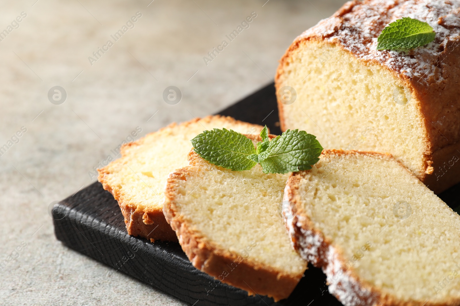 Photo of Freshly baked sponge cake on light grey table, closeup