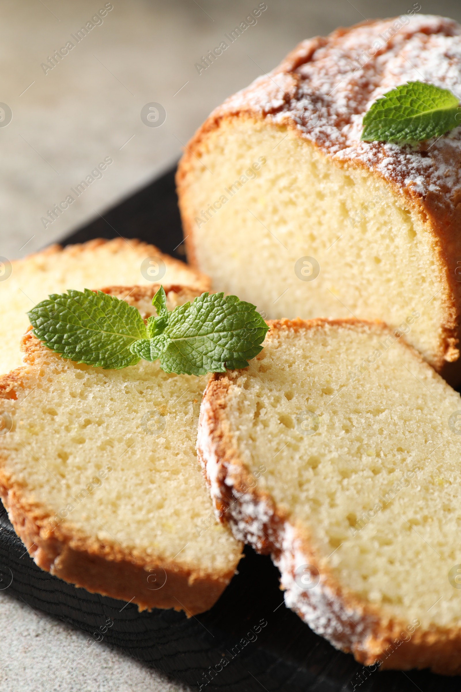 Photo of Freshly baked sponge cake on light grey table, closeup