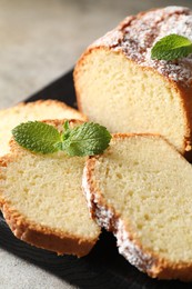 Photo of Freshly baked sponge cake on light grey table, closeup