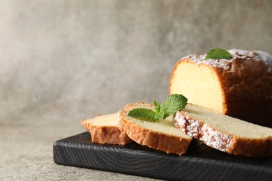 Photo of Freshly baked sponge cake on light grey table, closeup