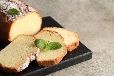 Photo of Freshly baked sponge cake on light grey table, closeup