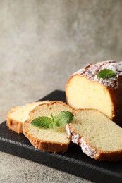 Photo of Freshly baked sponge cake on light grey table, closeup