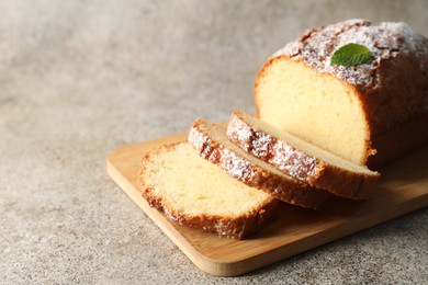 Photo of Freshly baked sponge cake on light grey table, closeup