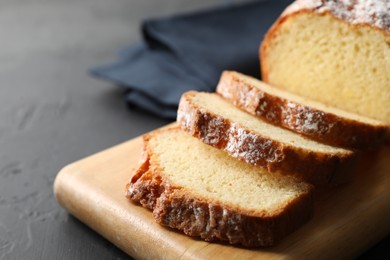 Photo of Freshly baked sponge cake on black table, closeup