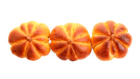 Photo of Tasty pumpkin shaped buns isolated on white, top view