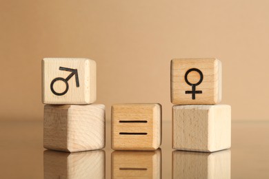 Photo of Gender equality concept. Cubes with male and female symbols on beige background